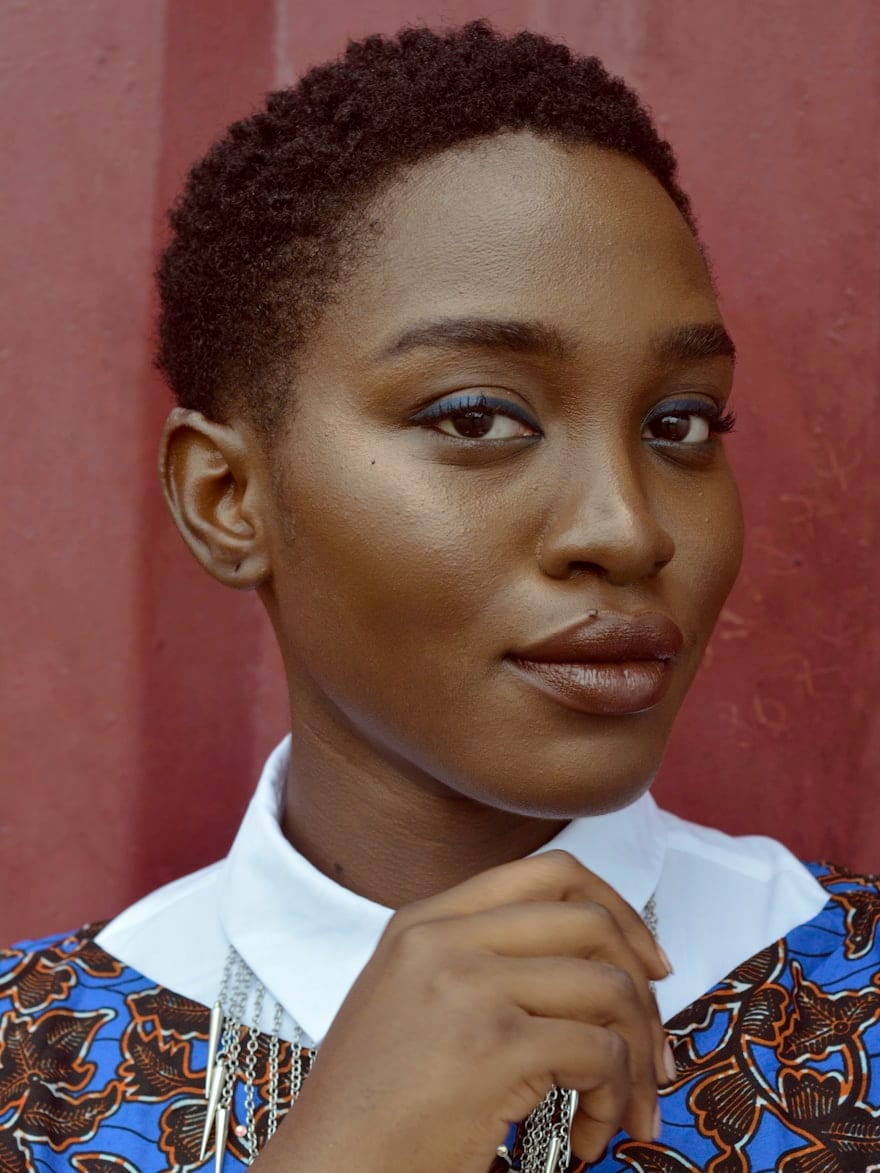 A woman in quiet stillness — editorial portrait against foliage
